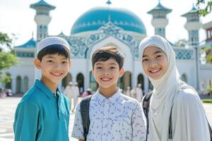 Three muslim children posing for a photo in front of a mosque