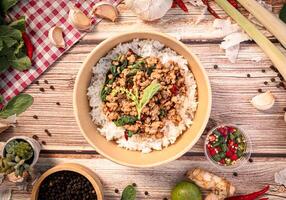 The Pork with basil in paper Bowl for Thai food concept. photo