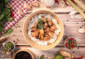 The Chicken with basil in paper Bowl for Thai food concept. photo