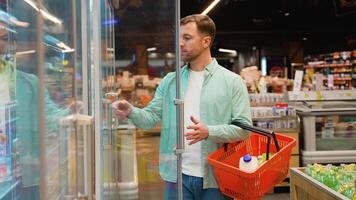 Customer choosing eggs in supermarket refrigerator video