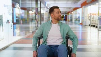 Man in wheelchair exploring modern shopping mall video