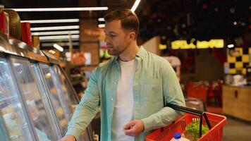 Customer choosing cheese from refrigerated display in supermarket video