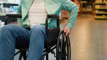 Customer using wheelchair moving through supermarket aisles video