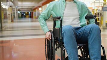 Man in wheelchair moving through shopping mall corridor video