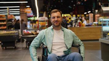 Portrait of happy customer in wheelchair smiling at camera in supermarket video