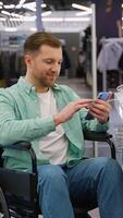 Customer using smartphone while charging it in electronics store video