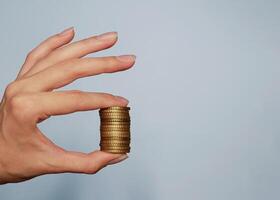 A stack of coins in a woman's hand close up. Background banner with copy space for text photo