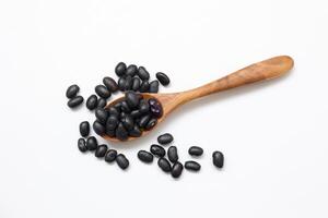 Black beans on white background, spoon with beans photo