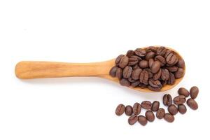 Brown coffeecoffee beans on a wooden spoon isolated on white background, photo