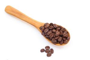 Brown bean, coffee beans in a wooden spoon on a white background photo