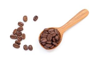 coffee beans in spoon on a white background photo