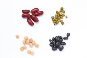 four different types of beans and beans on a white background photo
