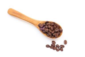 coffee beans in a wooden spoon on a white background photo