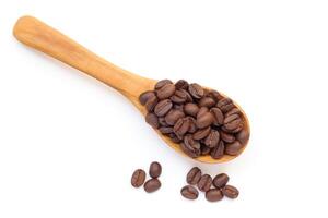 coffee beans in a wooden spoon isolated on white background photo