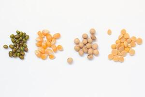 various types of beans and peas on a white background photo