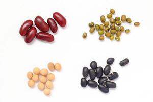 various types of beans and legumes on a white background photo