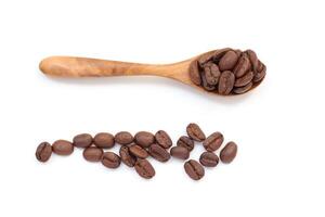 coffee beans on a wooden spoon and a spoon with coffee beans on it photo
