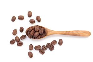 Coffee beans in spoon, brown roasted coffee beans in wooden spoon on white background, macro beans photo