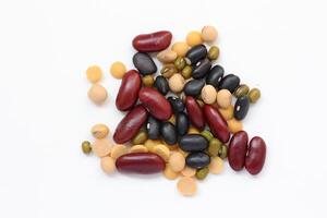 a pile of beans and other legumes on a white background photo