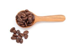 coffee beans in wooden spoon on white background photo