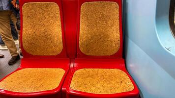 Retro red subway seats, echoing urban nostalgia, evoke vibrant journeys, perfect for Transit Equity Day and World Design Day photo