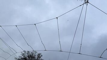 Wind weary netting embraces the moody sky, whispering of forgotten kite festivals and elusive dreams caught mid air photo