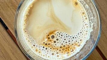 Frothy latte swirls invite cozy hygge vibes, celebrating Caffeine Awareness Month and International Coffee Day, aromatic brew indulgence photo
