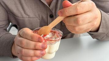 Gentleman enjoying creamy delight, strawberry swirl yogurt ritual, Nordic Midwinter Feast indulgence, playful blend of textures and flavors photo