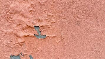 Crumbled peach wall texture revealing secrets beneath, echoing Wabi Sabi aesthetics and the haunting allure of Ghost Festival photo