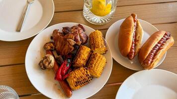 Grilled cornucopia with charred corn, sizzling meats, and savory buns, perfect for a midsummer cookout or National Barbecue Day photo