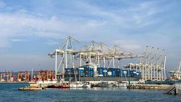 Industrial symphony of towering port cranes, bustling with cobalt containers for Seafarers Day and obscure National Logistics Week photo