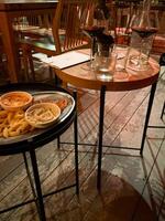 Cozy cafe ambiance with unfinished fries and swirling red wine, perfect for solitary musings or Diwali dinner reflections photo