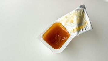 Golden nectar pools in a condiment cup, evoking moments of sweet simplicity and Pancake Day delight photo