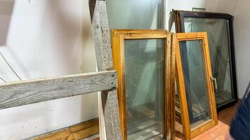 Abandoned window frames lean wistfully, dreaming of bygone vistas, perfect for World Architecture Day or National Recycling Month photo