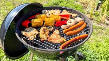 Sizzling barbecue feast on the grill, vibrant corn and sausages, evoking summer solstice celebrations and National BBQ Day photo