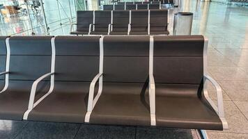 Empty airport bench whispers tales of fleeting wanderlust during Diwali and Chuseok, modern liminal spaces in travel reverie photo