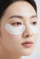 A woman with eye patches on her face photo