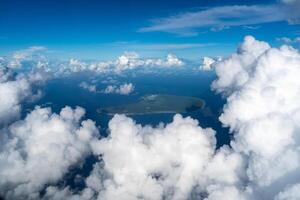 Aerial view of Makatea Island surrounded by clouds in French Polynesia photo