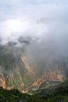 Colca Canyon and river in the mist and clouds, Peru photo