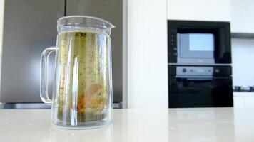 A pitcher of water with fish in it sitting on a counter video