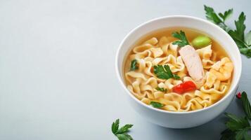 Close-up of a white bowl filled with steaming chicken noodle soup with vegetables and herbs on a white surface, fresh parsley garnished for flavorful comfort food photo