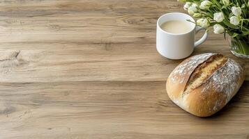 Rustic Wooden Tabletop Still Life with Crusty Bread, Creamy Beverage, and White Flowers photo