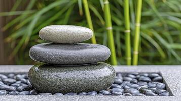 Three Stacked Stones in a Zen Garden Setting photo