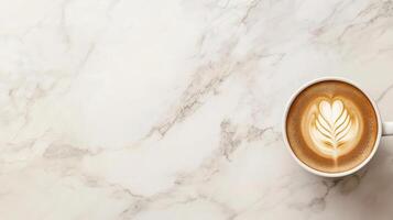 A cup of coffee with a heart design on a marble surface photo