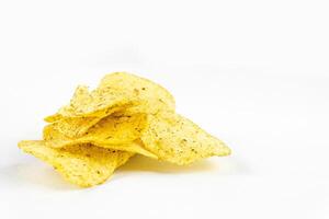 A pile of seasoned potato chips are displayed against a clean, white background, isolated. photo