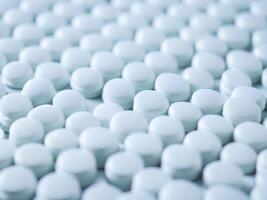 White pills arranged on a white background photo