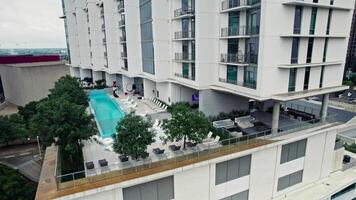Terrace with a swimming pool on the upper floors of a skyscraper. Bird's eye view from a drone photo