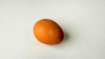 An enigmatic auburn egg on a blank canvas whispers Easters mysteries, embodying the essence of fertility and rebirth photo