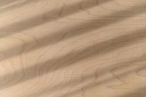 Natural wood texture features diagonal shadows and parallel light stripes creating an abstract background pattern on smooth brown surface. detail shows subtle wood grain of organic material photo