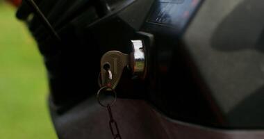 Close up of a key in a tractor ignition switch. Male hand turns the key, starting the agricultural machine photo